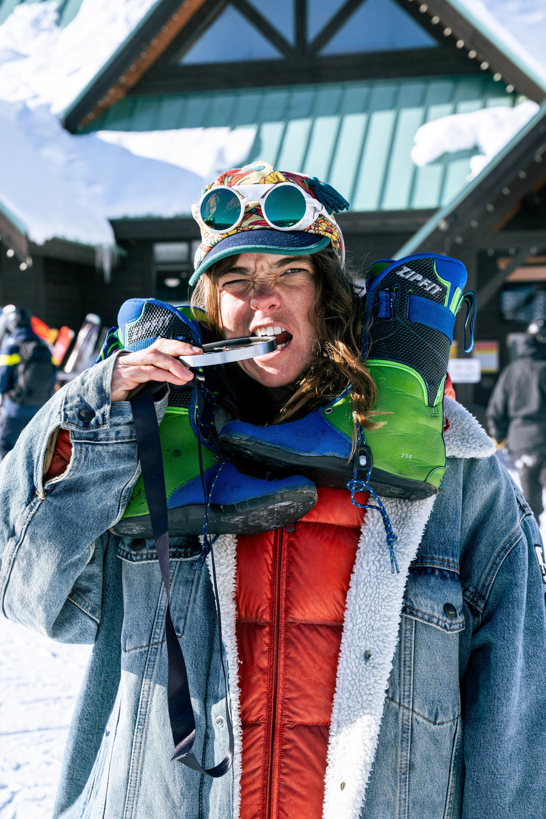Molly Armanino biting a medal with ZipFit liners around her neck. 